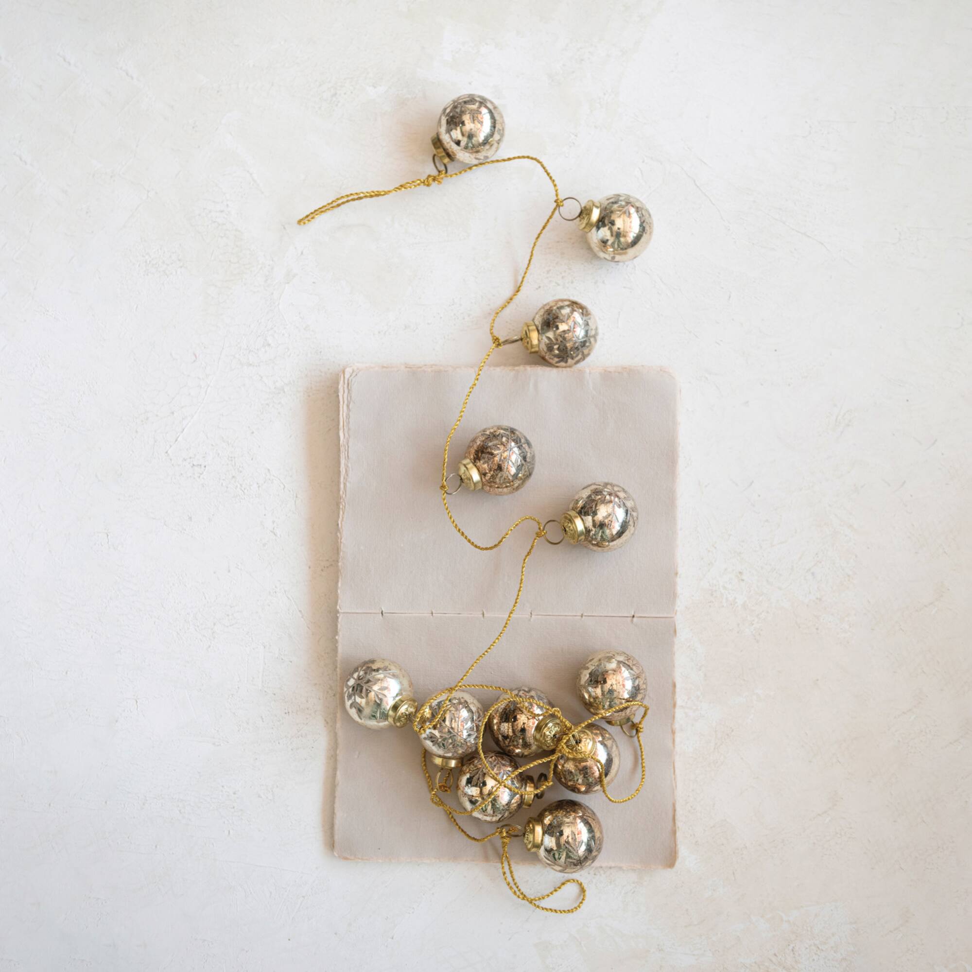 Hello Honey® 6ft. Antique Gold Etched Mercury Glass Ball Ornament Garland with Snowflakes